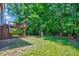 Spacious backyard with lush greenery, complemented by a wooden deck and serene natural backdrop at 2501 Springfield Park Dr, Raleigh, NC 27614