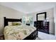 Bright bedroom features a floral comforter and a dark wood dresser with a matching mirror at 2501 Springfield Park Dr, Raleigh, NC 27614