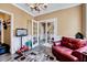 Cozy bonus room with white molding, decorative rug, and a leather sofa at 2501 Springfield Park Dr, Raleigh, NC 27614