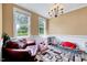 Cozy bonus room with two windows, stylish chandelier, and carpet with geometric design at 2501 Springfield Park Dr, Raleigh, NC 27614