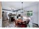Open-concept kitchen and dining area that is well-lit with natural light and access to a deck through a sliding glass door at 2501 Springfield Park Dr, Raleigh, NC 27614