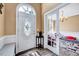 Inviting foyer with decorative door, wood floors, and view of a bonus room through glass doors at 2501 Springfield Park Dr, Raleigh, NC 27614