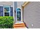 Close up of a welcoming front entrance with storm door, brick steps and 'Welcome' sign at 2501 Springfield Park Dr, Raleigh, NC 27614