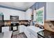 Kitchen featuring white cabinetry, stainless steel appliances, a farmhouse sink and granite countertops at 2501 Springfield Park Dr, Raleigh, NC 27614