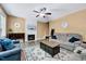 Living room with a fireplace, a ceiling fan, and neutral wall paint at 2501 Springfield Park Dr, Raleigh, NC 27614