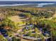 Aerial view of a golf course, clubhouse, and a lake surrounded by a forest at 259 Brown Bear, Chapel Hill, NC 27517