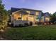 The backyard features a patio with outdoor dining, a hot tub, and manicured landscaping at 259 Brown Bear, Chapel Hill, NC 27517