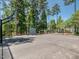 Fenced basketball court with green trees in background and playground in the distance at 259 Brown Bear, Chapel Hill, NC 27517