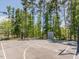Outdoor basketball court with well-maintained surface and sturdy hoops surrounded by mature trees at 259 Brown Bear, Chapel Hill, NC 27517