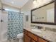 Bathroom features a shower with blue patterned curtain, granite vanity, and ample lighting at 259 Brown Bear, Chapel Hill, NC 27517