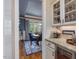 Open view from the butler's pantry into a dining area with blue walls, wainscoting, and hardwood flooring at 259 Brown Bear, Chapel Hill, NC 27517