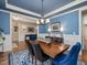 Bright dining room featuring a blue accent wall, wainscoting, and a hardwood floor beneath the dining set at 259 Brown Bear, Chapel Hill, NC 27517