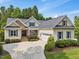 Inviting single-Gathering home featuring a landscaped front yard and attached two-car garage, complemented by stylish stone accents at 259 Brown Bear, Chapel Hill, NC 27517
