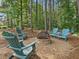 Backyard fire pit area with Adirondack chairs surrounded by tall trees at 259 Brown Bear, Chapel Hill, NC 27517