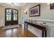 Warm foyer showcases hardwood flooring and double front doors with glass detailing, complemented by elegant console table at 259 Brown Bear, Chapel Hill, NC 27517