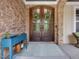 Attractive home entrance features a brick facade, double doors with glass panels, and a covered porch at 259 Brown Bear, Chapel Hill, NC 27517
