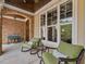 Charming front porch with rocking chairs and views of the front yard landscaping and brick detailing at 259 Brown Bear, Chapel Hill, NC 27517
