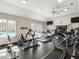 Well-equipped fitness center with treadmills, stationary bikes, and ample natural light near the pool at 259 Brown Bear, Chapel Hill, NC 27517