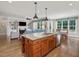 Open-concept kitchen with island seating flows into living area with fireplace and bright dining space at 259 Brown Bear, Chapel Hill, NC 27517
