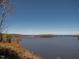 A peaceful lake with trees along the shoreline creates a tranquil and scenic view at 259 Brown Bear, Chapel Hill, NC 27517