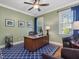 Office with a large wooden desk, blue rug, and natural light from two windows at 259 Brown Bear, Chapel Hill, NC 27517