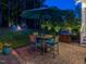 Evening view of the outdoor brick patio with a table, chairs, grill, and backyard fire pit at 259 Brown Bear, Chapel Hill, NC 27517