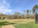 A grassy soccer field sits among beautiful trees with blue skies at this community at 259 Brown Bear, Chapel Hill, NC 27517