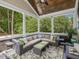Relaxing screened-in porch features comfortable seating, a ceiling fan, and views of surrounding greenery at 259 Brown Bear, Chapel Hill, NC 27517