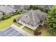 Aerial view of brick home with covered porch, manicured lawn, and ample parking at 260 Easy Wind Ln, Garner, NC 27529
