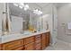 Bathroom with double sink vanity, granite countertop, wood cabinets and a large mirror at 260 Easy Wind Ln, Garner, NC 27529