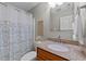 Cozy bathroom with patterned shower curtain and granite countertop vanity at 260 Easy Wind Ln, Garner, NC 27529