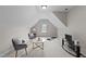 Bonus room features comfortable seating, a flat screen tv, and a yoga mat at 260 Easy Wind Ln, Garner, NC 27529