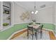A dining room features an accent wall, classic lighting, and seating for four at 260 Easy Wind Ln, Garner, NC 27529