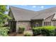 Brick home featuring a manicured lawn, trimmed hedges, and a gray roof at 260 Easy Wind Ln, Garner, NC 27529