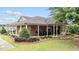 Charming brick home with a welcoming porch and well-maintained landscaping at 260 Easy Wind Ln, Garner, NC 27529