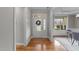 Bright foyer with hardwood floors, decorative glass door, transom window and views into other rooms at 260 Easy Wind Ln, Garner, NC 27529