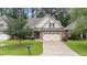 Charming home with stone accents, two-car garage, well-maintained lawn, and inviting landscaping at 260 Easy Wind Ln, Garner, NC 27529