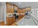 A spacious kitchen features stainless appliances, light granite countertops and wood flooring at 260 Easy Wind Ln, Garner, NC 27529