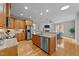 Open-concept kitchen boasts stainless appliances, granite counters, and an island with eat-in breakfast bar at 260 Easy Wind Ln, Garner, NC 27529