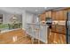 Kitchen features granite counters, stainless appliances, and breakfast bar seating into a dining area at 260 Easy Wind Ln, Garner, NC 27529