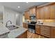 A spacious kitchen features stainless appliances, light granite countertops and wood flooring at 260 Easy Wind Ln, Garner, NC 27529