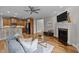 Open-concept living room with hardwood floors, a fireplace, and a view into the kitchen area at 260 Easy Wind Ln, Garner, NC 27529