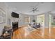 Bright living room with fireplace, large windows, hardwood floors, and a comfortable seating arrangement at 260 Easy Wind Ln, Garner, NC 27529