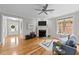 Spacious living room with hardwood floors, fireplace, ceiling fan, and comfortable seating at 260 Easy Wind Ln, Garner, NC 27529