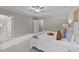 Bright main bedroom features neutral colors, tray ceiling with fan, and ensuite bathroom at 260 Easy Wind Ln, Garner, NC 27529
