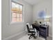 Bright home office features a dark desk and chair and a view out the window at 260 Easy Wind Ln, Garner, NC 27529