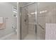 Glass enclosed shower featuring neutral colored tile and a convenient grab bar at 260 Easy Wind Ln, Garner, NC 27529