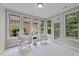 Sunroom features rocking chairs, an abundance of natural light, and access to the back yard at 260 Easy Wind Ln, Garner, NC 27529