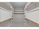 Spacious walk-in closet with built-in shelving and wooden clothes rods at 260 Easy Wind Ln, Garner, NC 27529