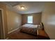 Comfortable bedroom with a floral-patterned bedspread and natural light from the window at 2657 Joel Johnson Rd, Lillington, NC 27546